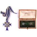 Third Reich Mother's Cross in silver, with ribbon; and a pair of modern swastika ear studs in non-