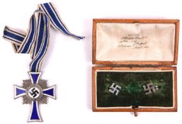 Third Reich Mother's Cross in silver, with ribbon; and a pair of modern swastika ear studs in non-