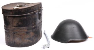 An E German Volksarmee steel helmet, dark green with pale brown leather padded liner and