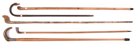 4 walking sticks: short plain dark wood with painted, carved duck's head finial; plain wood with