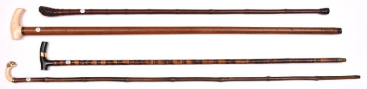 3 walking sticks slender bamboo, the polished dark green stone handle having a gold “ coloured band;