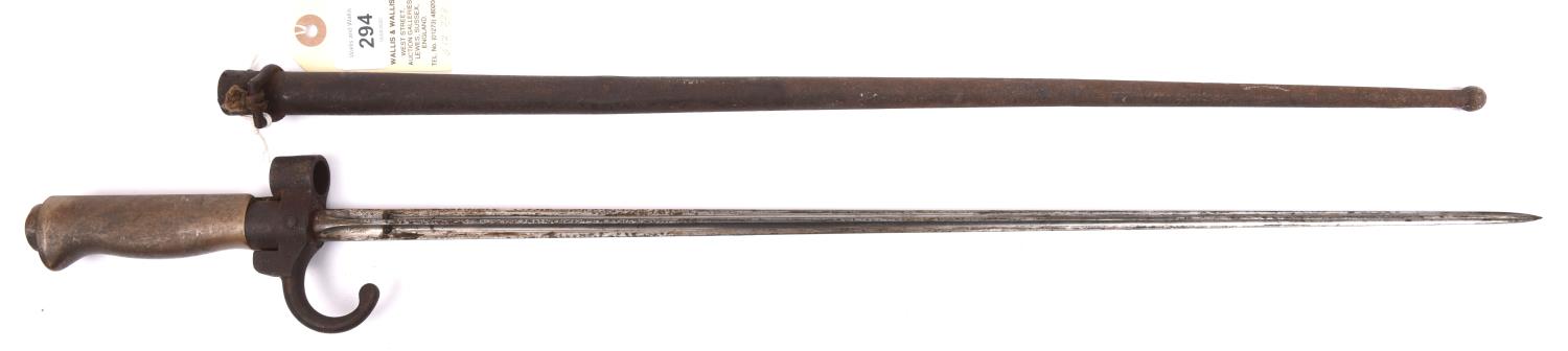 A Lebel bayonet, cruciform section blade, hooked quillon, WM grip, in its steel scabbard.