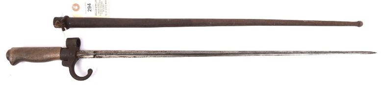 A Lebel bayonet, cruciform section blade, hooked quillon, WM grip, in its steel scabbard.