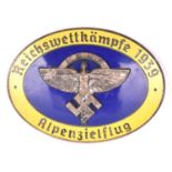 A Third Reich oval enamelled pin back badge, superimposed in the centre is the NSFK emblem in