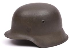 A German M42 single decal Waffen-SS steel helmet, with maker's code and serial number to rear edge(