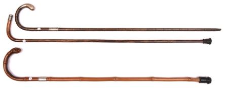 3 slender walking sticks; one-piece bamboo with scroll-engraved silver finial and band (HM London