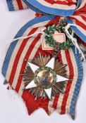 Liberia: Order of African Redemption sash and sash badge, in gilt with 5 pointed white enamelled