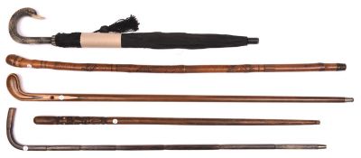 2 walking sticks laminated and inlaid wood with simple handle reminiscent of early golf clubs; and