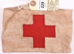 A Red Cross buff linen armband, with superimposed cross, the back bearing indistinct Air Ministry