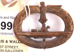 A Third Reich U-Boat badge, of gilt brass with round wire pin and maker's mark “GWL”, GC (little