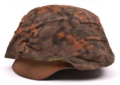 A German M40 ? type steel helmet, lacking maker's mark and serial number, with leather liner and