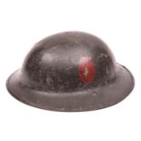 A WWI Brodie's pattern steel helmet, dark green painted finish (some wear), with plain red oval
