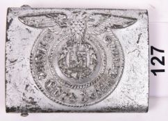 A Third Reich SS man's belt buckle, of silver-painted steel, the back stamped with RZM mark, “155/