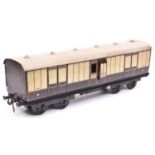 A Carette Gauge 2 L.N.W.R. Passenger Full Brake. A bogie coach in lined brown and cream livery.