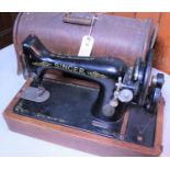 A 1920s Singer Sewing Machine No.99 (hand turned) in an oak veneered case. With orginal