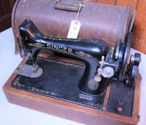 A 1920s Singer Sewing Machine No.99 (hand turned) in an oak veneered case. With orginal