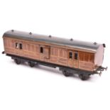 A Carette Gauge One non-corridor bogie guards van. A G.N.R. example in lined teak effect livery,