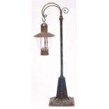 A Gauge One railway lamp by Bing. A cast lamp stand with tinplate base and brass lamp holder with