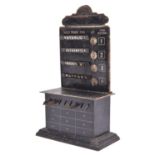 A Gauge One Bing tinplate Destination Board. Black painted cabinet with 4x hooked display slots with
