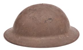 A WWI Brodie’s pattern steel helmet, oilcloth, netting, leather and fabric lining, fragment of