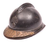 A WWI French Army Adrian steel helmet, grenade badge, and commemorative brass plate fixed to front