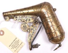 A Persian brass powder flask of horn shape, late 19th century, 16cms, engraved with foliage overall,