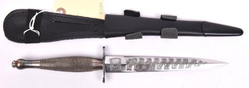 A Philippines commemorative FS fighting knife, blade etched with battle honours, in its scabbard.