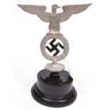 A Third Reich cast aluminium SA type eagle banner top, with black painted voided swastika and disc