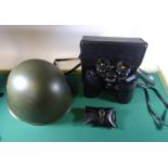An East German military helmet, a Commodore 12x50 binocular in case; also a rifle cleaning kit in