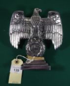 A Third Reich polished cast aluminium desk eagle, with integral rectangular base and threaded hole
