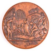 A circular carved fruitwood patch box, the lid carved with the scene of Napoleon’s burial on St.