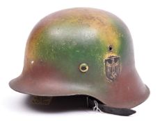 A Third Reich M43 raw edge steel helmet, camouflage finish, single decal. GC £100-120.