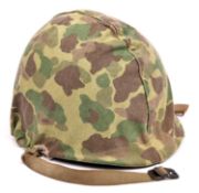 A WWII US Mark I steel helmet, with fixed chinstrap loops and webbing chinstrap (worn), removable