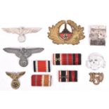 A Third Reich SS grey metal cap eagle; an SS death’s head with RZM mark; 2 other metal cap eagles; a