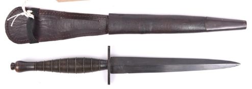 A scarce FS fighting knife, ribbed and beaded variety, black reblackened. In its scabbard (tabs