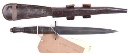 A WWII 3rd Pattern FS fighting knife, blued blade, ribbed handle, in its scabbard. Above average GC.
