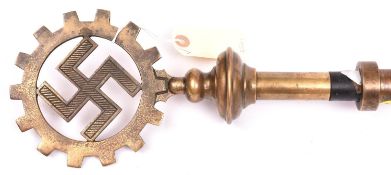 A Third Reich DAF (Deutsche Arbeitsfront) swastika in cogwheel brass standard top, mounted on a