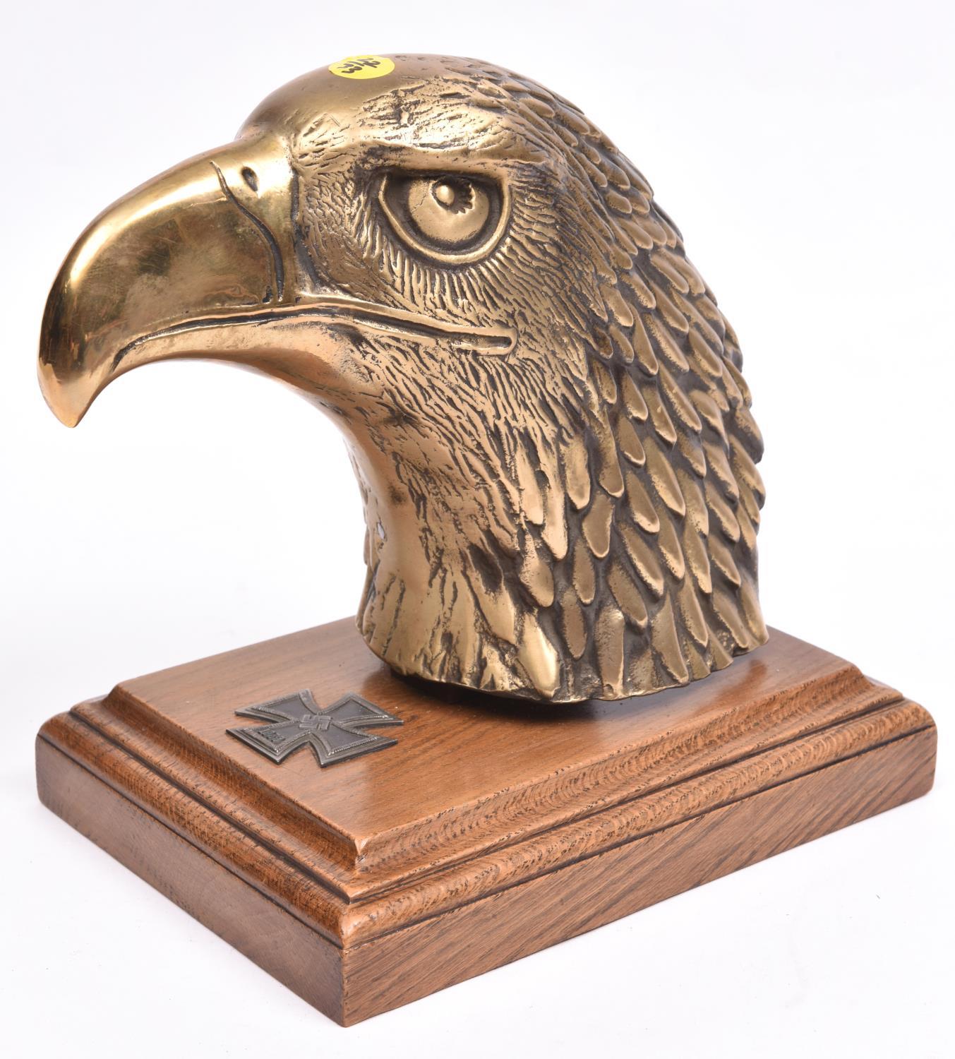 A Third Reich desk ornament, consisting of a large hollow cast brass eagle’s head and a 1939 first