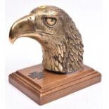 A Third Reich desk ornament, consisting of a large hollow cast brass eagle’s head and a 1939 first