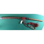 A Burmese dha, blade 21", with woven rattan bound hilt, the plain wood sheath bound with banks of