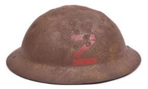 A WWI raw edge Brodie’s pattern steel helmet, red painted black letter “Z” (Channel Islands ?),