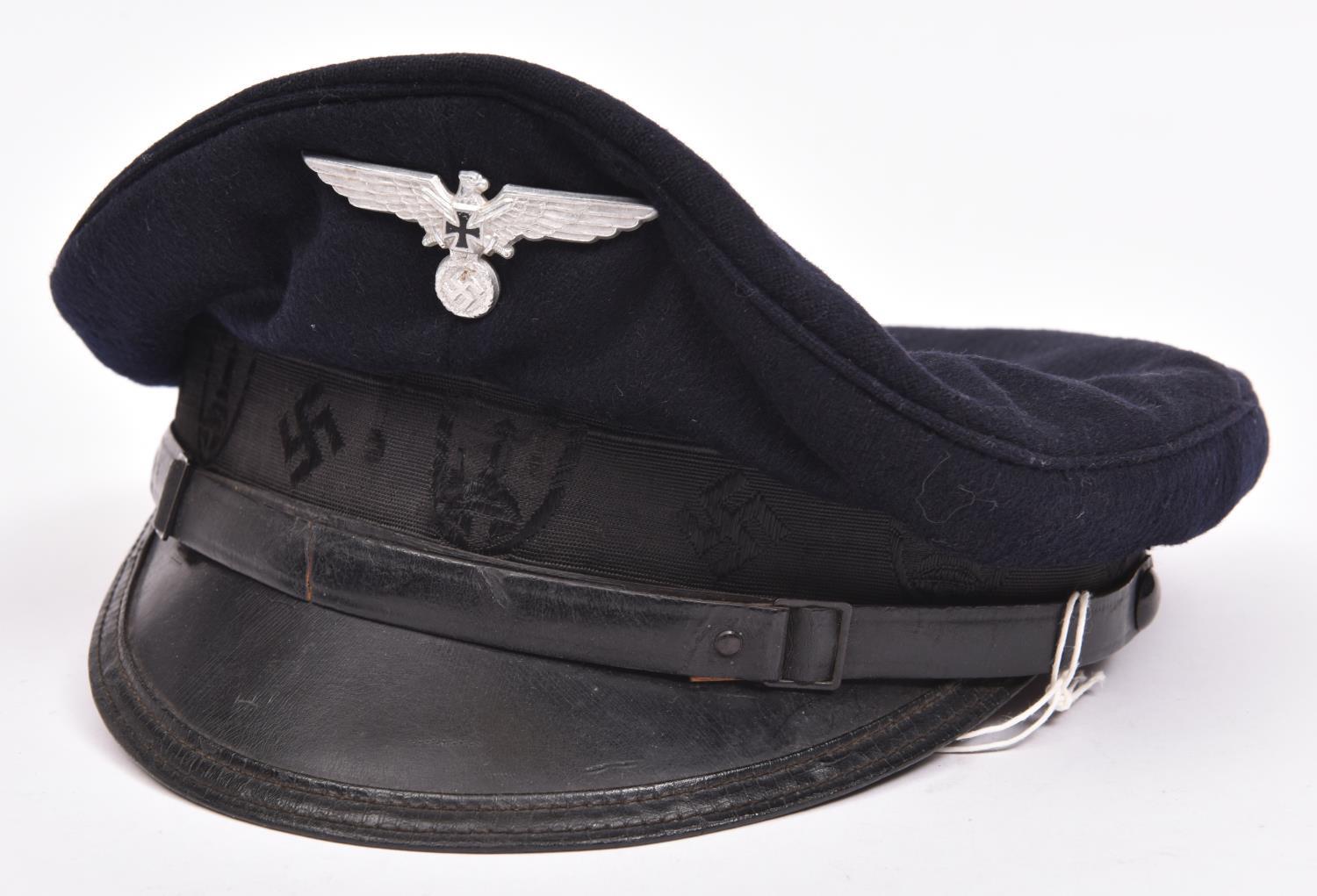 A Third Reich Kuffhauserbund peaked cap, with aluminium badge, fibre peak, embroidered band, leather