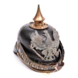 A WWI Imperial German OR’s infantry pickelhaube, brass mounts and chin scales. GC (badge possibly