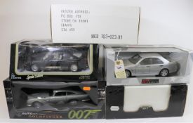 5 1:18 scale cars. A UT Models Mercedes-Benz C36 AMG in silver. An AUTOart 'Goldfinger 007' Aston-