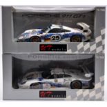 2 UT Models 1:18 scale Porsche 911 GT1 racing cars. An example in Mobil 1 white/blue patterned