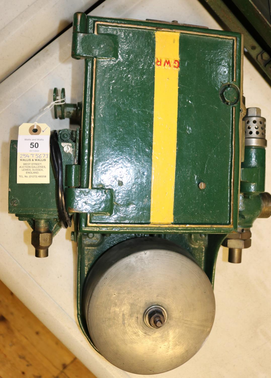 A GWR locomotive cab AWS Warning Bell in green painted cast case with brass tag to side, 261. Approx