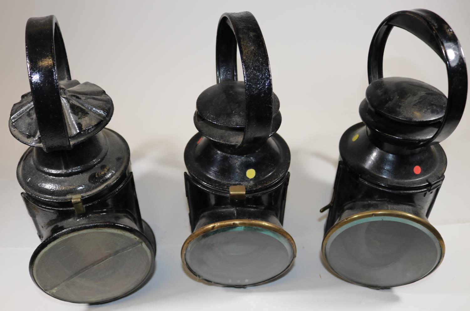 3x Railway Hand Lamps. A 3-aspect BR(E) example with brass plaque for 'Helpston' to one side. An LMS