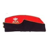 A Vic Officer’s scarlet and blue field cap of the 12th Royal Lancers, gilt bullion trim, gilt QC