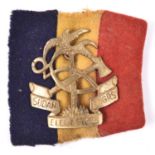 A scarce brass cap badge of the Sudan Elec & Mech Engrs, with original red, black and yellow cloth