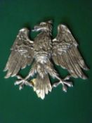 A polished cast aluminium heraldic spread eagle, with 3 crowns on its breast and wings, as used by